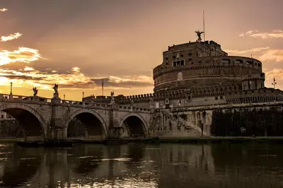 a bridge over a river with a building at Virgilio Suite in Rome