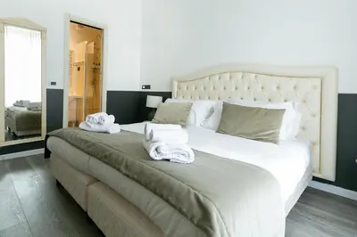 a bedroom with a bed and a desk with a computer at Capitolium Rooms in Rome