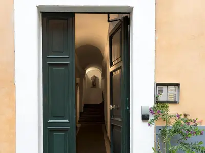 a green door leading into a hallway at JR Suites in Rome