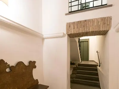 a staircase in a building with white walls at JR Suites in Rome