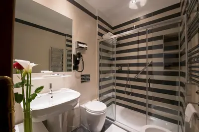 a bathroom with a toilet and a sink and a shower at JR Suites in Rome