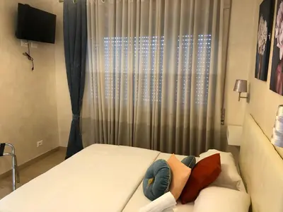 a bedroom with a large white bed with a window at Isabel in Rome