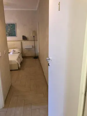 a room with a bedroom with a bed and a hallway at Isabel in Rome