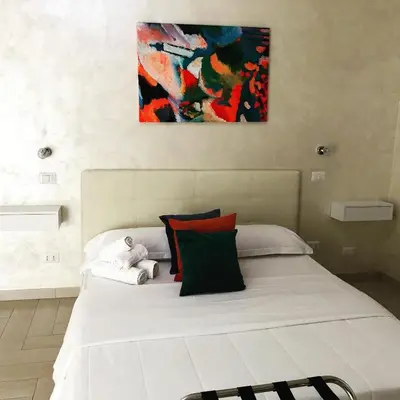 a bedroom with a large white bed with colorful pillows at Isabel in Rome