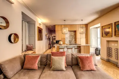 a living room with a couch and a kitchen at DeCharme apartment with terrace in Monti in Rome