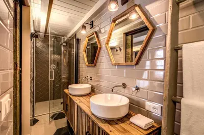 a bathroom with two sinks and a shower at DeCharme apartment with terrace in Monti in Rome