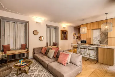 a living room with a couch and a kitchen at DeCharme apartment with terrace in Monti in Rome