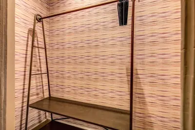 a glass shower with a ladder on a shelf at DeCharme apartment with terrace in Monti in Rome