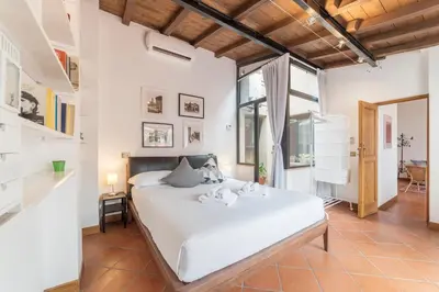 a bedroom with a white bed in a room at Monti Stairway to Heaven in Rome