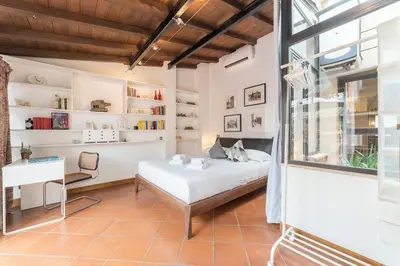a bedroom with a bed and a desk and a window at Monti Stairway to Heaven in Rome