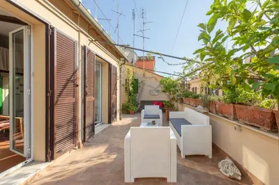 a balcony with white chairs and tables on a building at Monti Stairway to Heaven in Rome