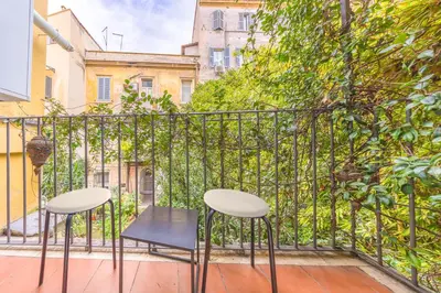 a pair of chairs and a table on a balcony at La Vaticana - Saint Peters View - Apt Rome in Rome