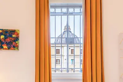 a window with a view of a building at La Vaticana - Saint Peters View - Apt Rome in Rome