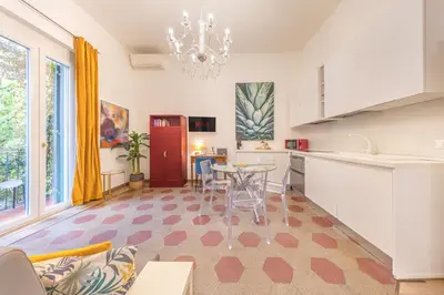 a kitchen and living room with a table and chairs at La Vaticana - Saint Peters View - Apt Rome in Rome