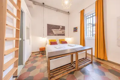 a room with a bed and a table in it at La Vaticana - Saint Peters View - Apt Rome in Rome
