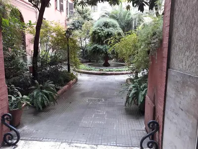 a walkway in a garden with trees and plants at Termini station holidays in Rome