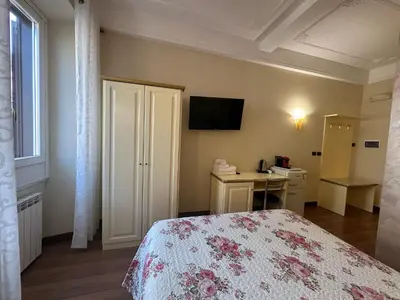 a bedroom with a bed and a television on the wall at Termini station holidays in Rome