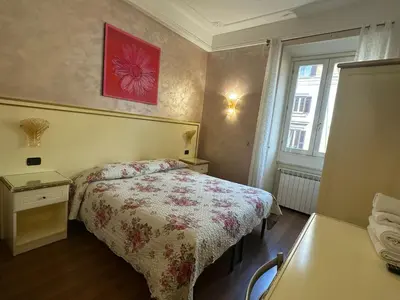 a bedroom with a bed and a red picture on the wall at Termini station holidays in Rome
