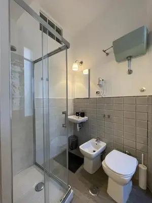 a bathroom with a shower and a toilet and a sink at Colazione Al Vaticano Guest House in Rome