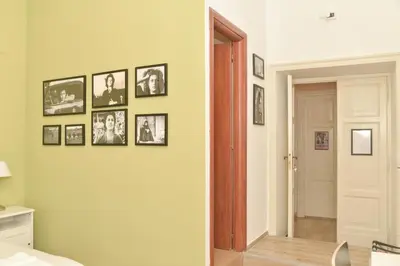 a hallway with pictures on a wall with a door at Colazione Al Vaticano Guest House in Rome