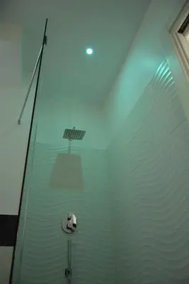 a glass shower with a white object in the water at Damiva in Rome