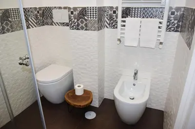 a small bathroom with a toilet and a sink at Damiva in Rome
