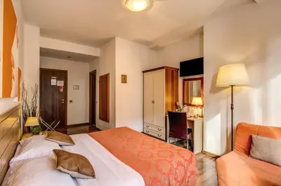 a hotel room with a bed and a couch at Trastevere Rooms in Rome
