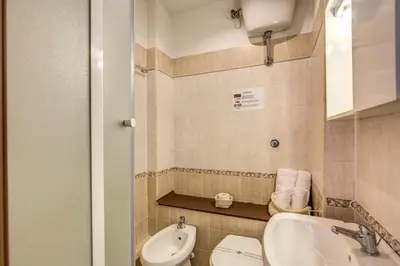 a bathroom with a sink and a toilet and a bidet at Trastevere Rooms in Rome
