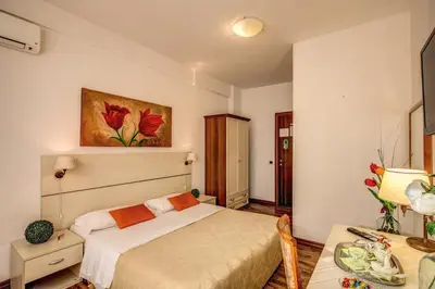 a bedroom with a bed and a table in it at Trastevere Rooms in Rome