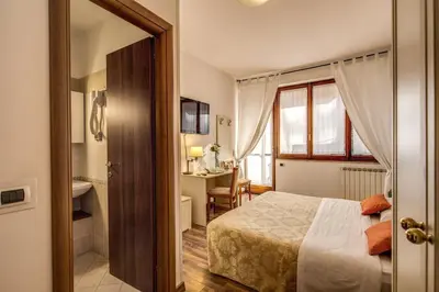 a hotel room with a bed and a bathroom at Trastevere Rooms in Rome