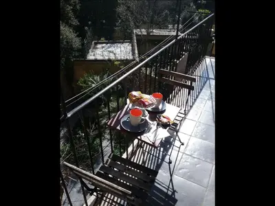 a table with food and drinks on a balcony at Merulana Suite in Rome
