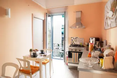 a small kitchen with a table and chairs and a stove at Merulana Suite in Rome