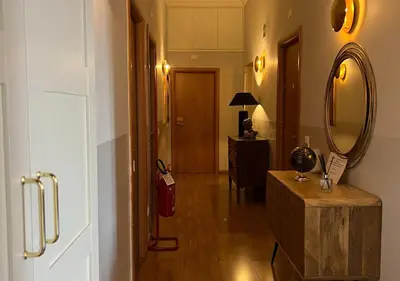 a hallway with a mirror and a wooden floor at Bon Ton Design Rooms by DOT Suites in Rome