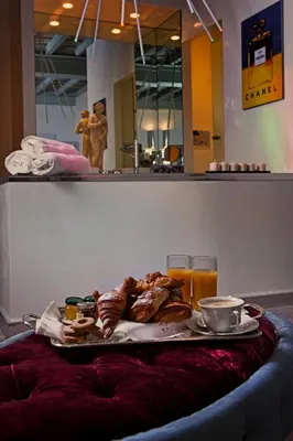 a tray of food on a table with orange juice at Pantheon Relais in Rome