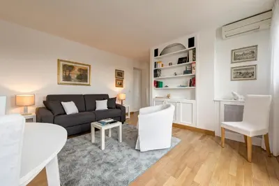 a living room with a couch and a table and chairs at Le case di Andrea Piccolomini San Peter - Terrace Flat in Rome