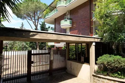 a house with a wooden gate and a fence at Le case di Andrea Piccolomini San Peter - Terrace Flat in Rome