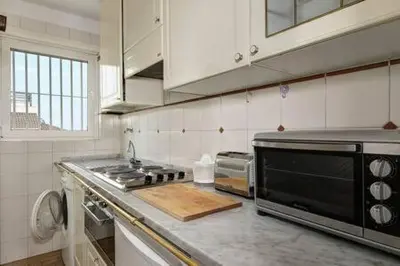 a kitchen with a stove and a microwave at Le case di Andrea Piccolomini San Peter - Terrace Flat in Rome