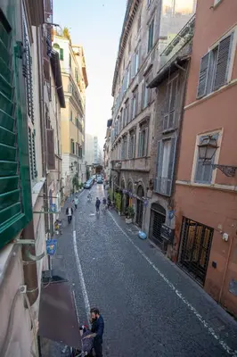 an empty street in an alley with buildings at maribea rome center in Rome