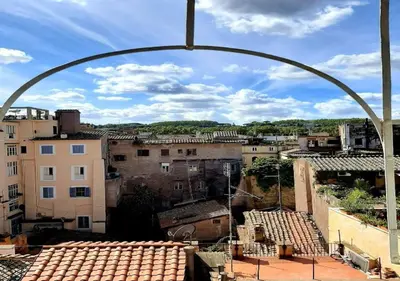 a view of a city from an arch over a city at Pellegrino 75 Double Bedroom in Rome