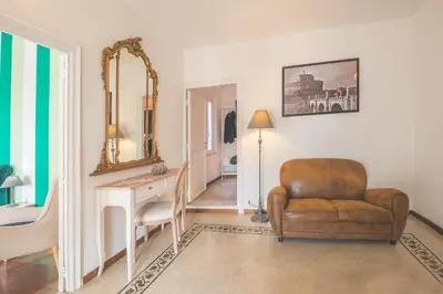 a room with a chair and a desk and a mirror at Pellegrino 75 Double Bedroom in Rome