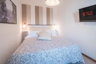 a bedroom with a bed with a blue and white comforter at Pellegrino 75 Double Bedroom in Rome