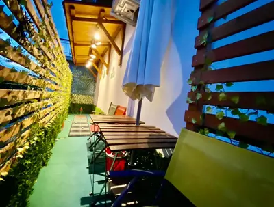 a row of tables with an umbrella on a patio at Elegant Vatican Metro & Golf Rome in Rome