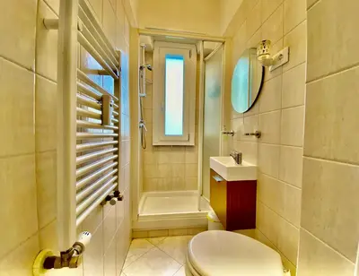 a bathroom with a toilet and a sink and a shower at Elegant Vatican Metro & Golf Rome in Rome