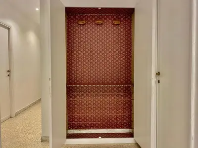 a red closet with stairs in a room at Elegant Vatican Metro & Golf Rome in Rome
