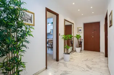 a hallway with potted plants in a house at Elegant Vatican Metro & Golf Rome in Rome