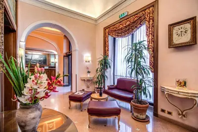 a living room with a couch and some plants at Hotel Della Torre Argentina in Rome