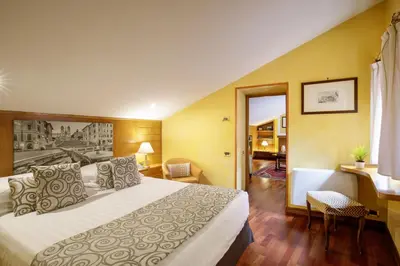 a hotel room with a bed and a desk at Hotel Della Torre Argentina in Rome