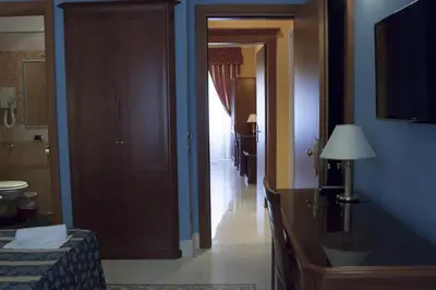 a room with a hallway with a door and a room with a bed at Clara Domus in Rome
