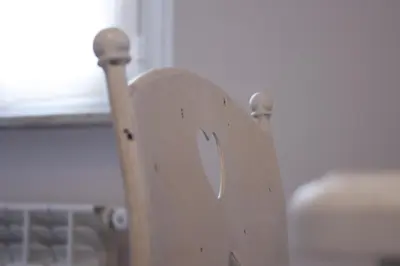 a wooden chair in a room with a window at Clara Domus in Rome