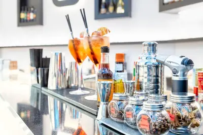 a counter with several bottles and glasses on it at THE ONE Boutique Hotel & SPA Roma in Rome